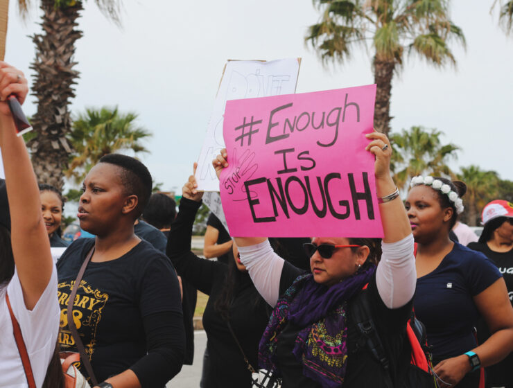 Port Elizabeth, South Africa - September 2019: A protester holding a sign that says "enough is enough" at a protest to remember women who were raped and killed in South Africa.