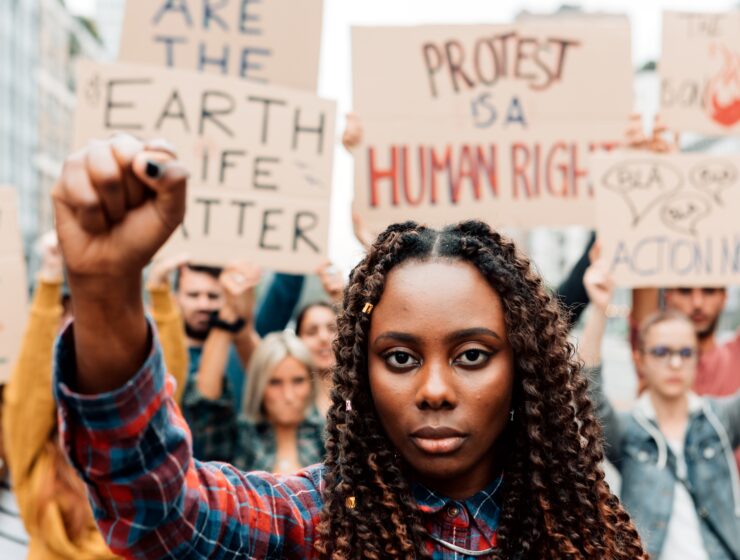 A young woman fist in the air during protest march